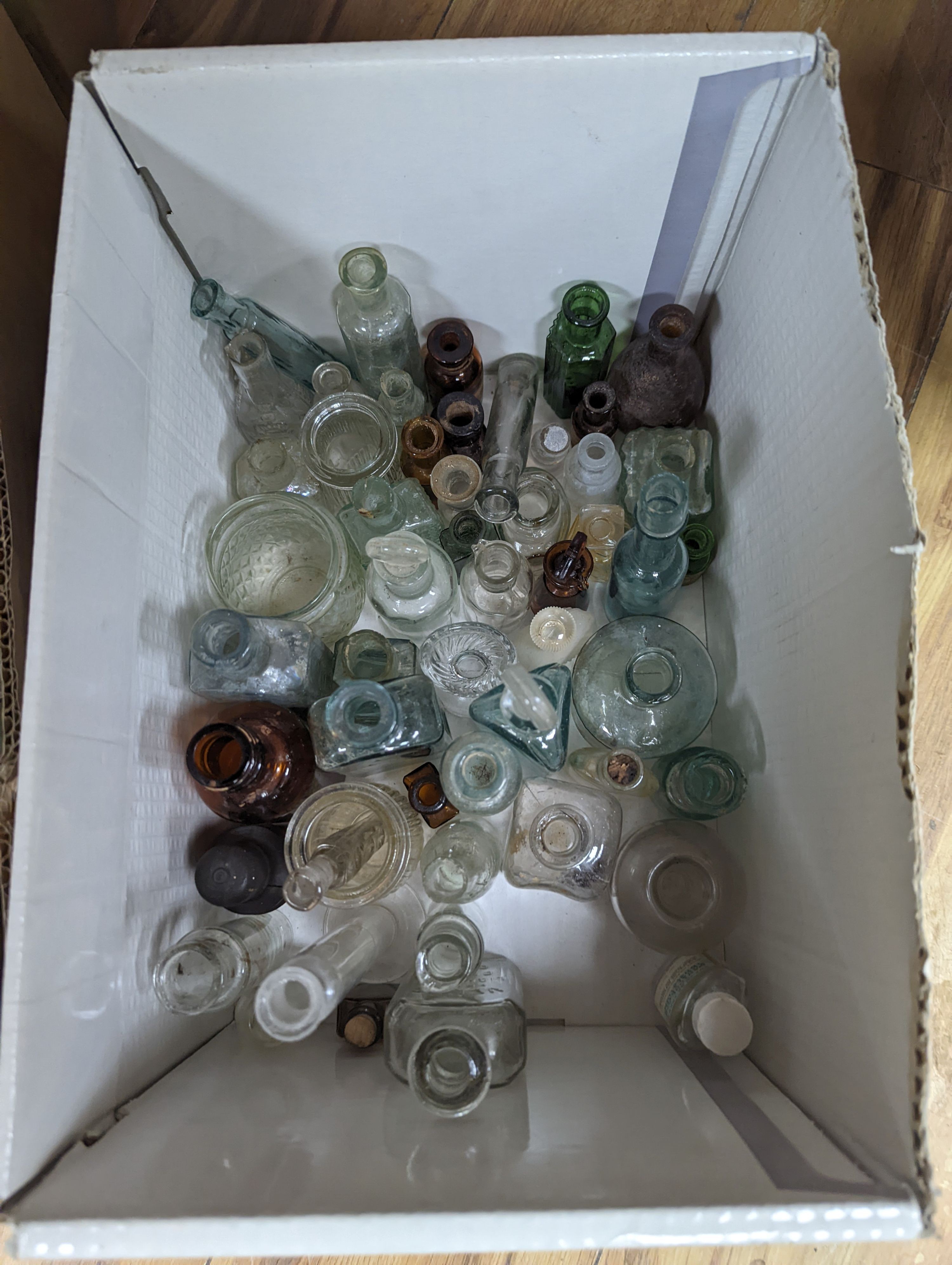 A collection of antique glass bottles and jars